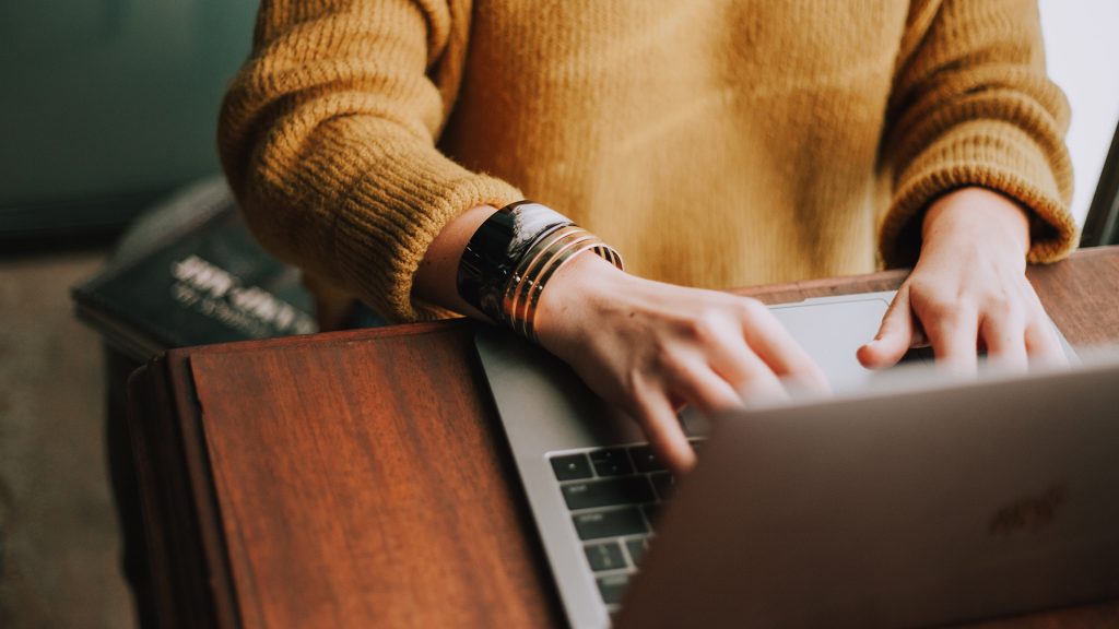 woman writing on the laptop