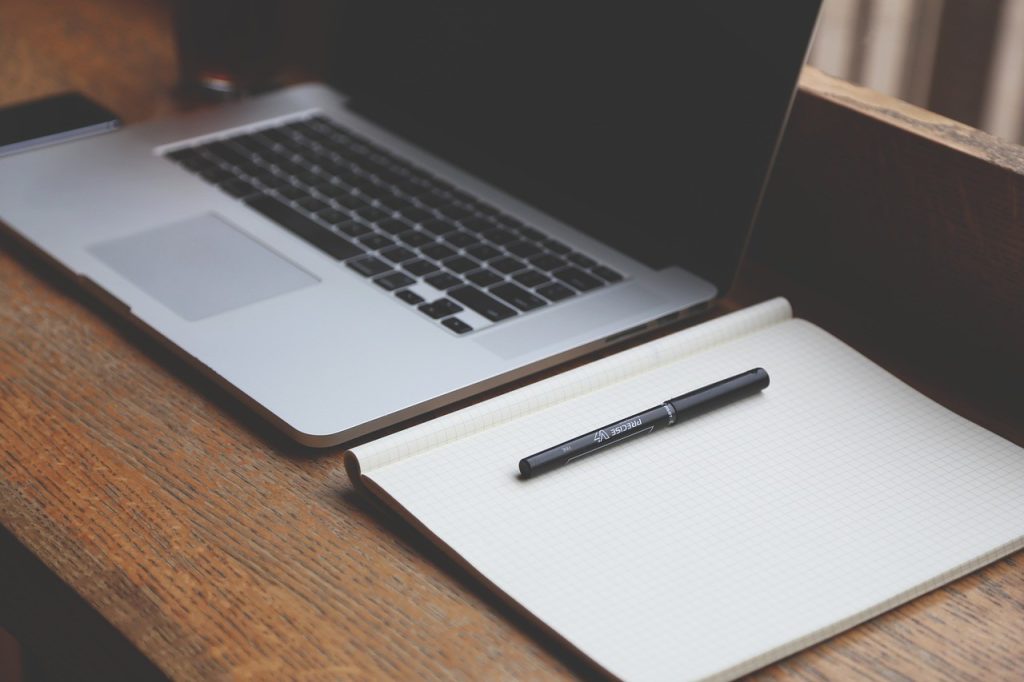 Laptop and notebook on the table