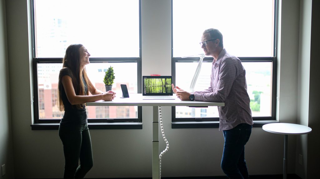 The standing desk and man and woman