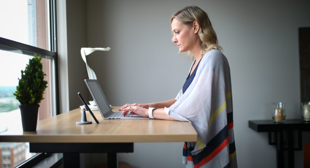 The standing desk and woman with the laptop