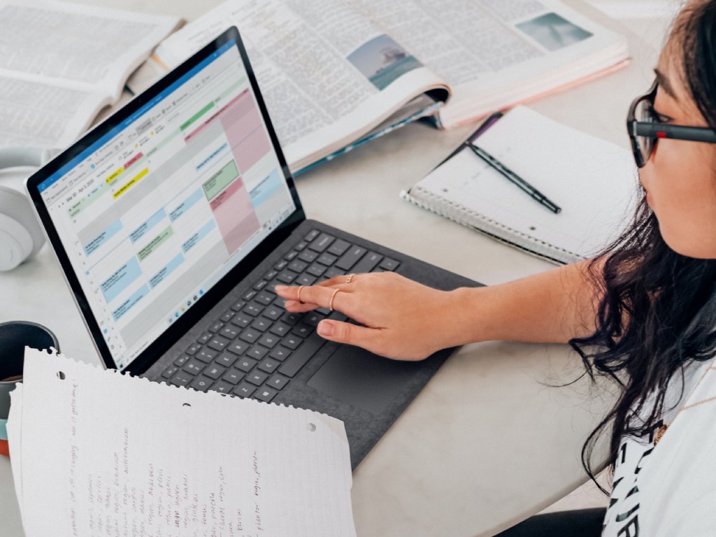 Woman with laptop and papers